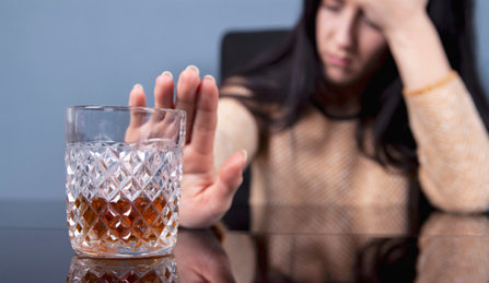 Woman refusing to drink more alcohol.