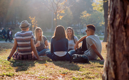 College students talking on a grass