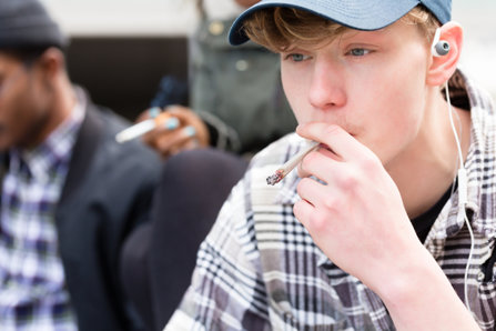 Teenager smoking marijuana with friend