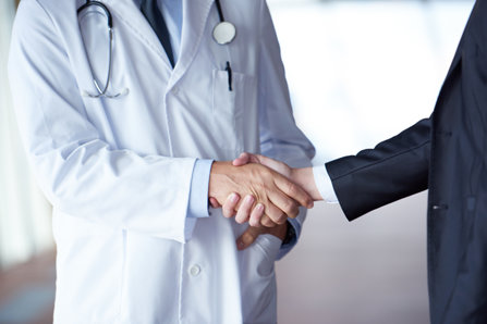 Doctor shakes hand with pharmacist