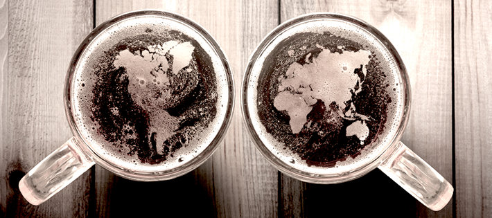 Two glasses of beer, with international map in it.